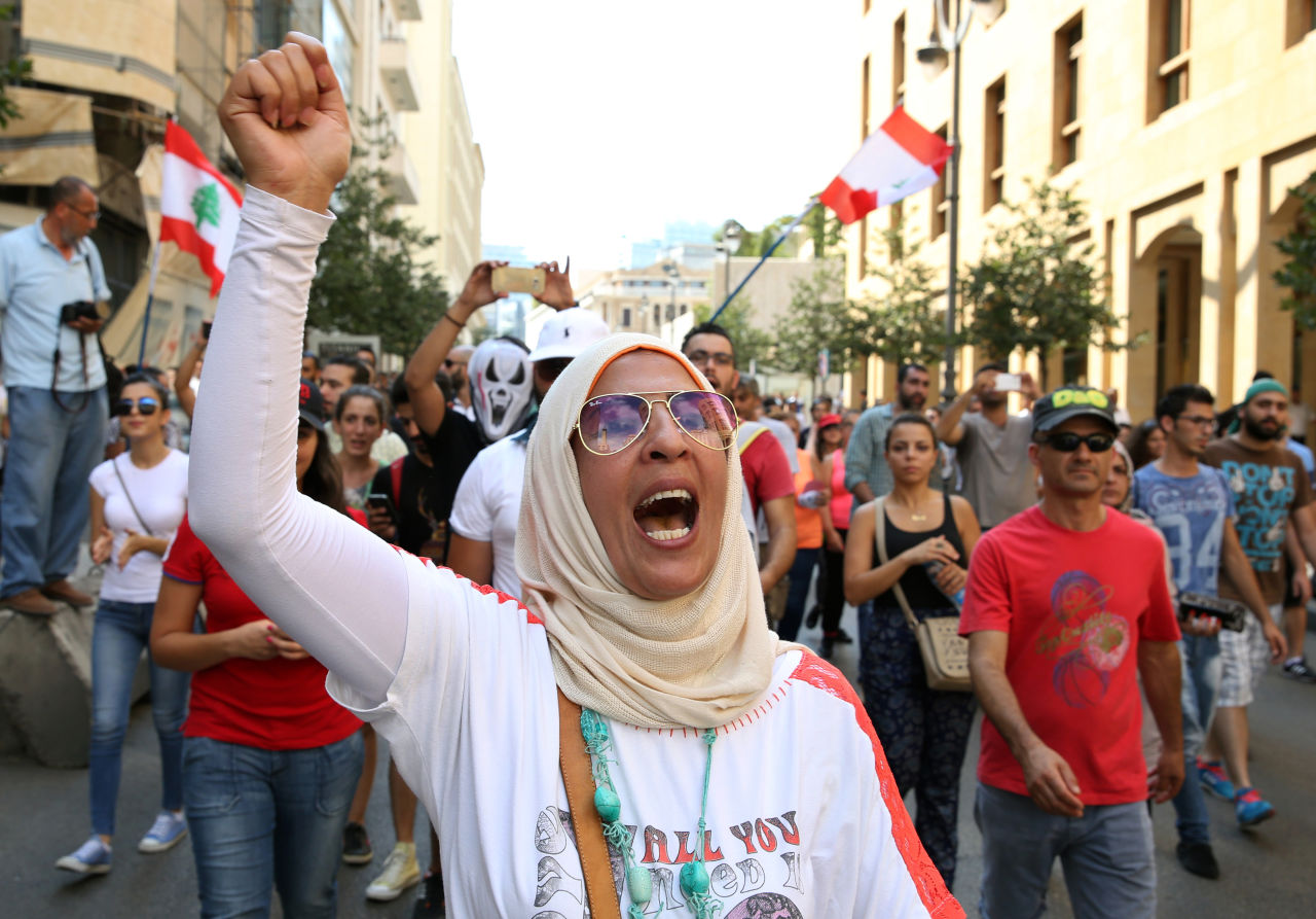 A Lebanese activist woman chants slogans during a protest against the ongoing trash crisis, in downtown Beirut, Lebanon, Sunday, Aug. 23, 2015. Thousands of protesters poured into central Beirut Sunday demanding government resignation hours after Prime Minister Tammam Salam hinted he might step down following violent protests against government corruption and political dysfunction triggered by a month long trash crisis in Beirut. (AP Photo/Bilal Hussein)